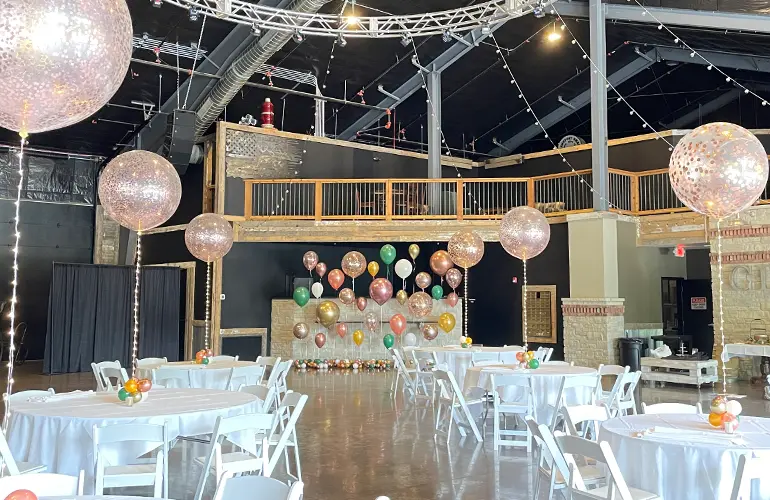 Glitter balloon centerpieces with helium balloon wall backdrop for wedding reception