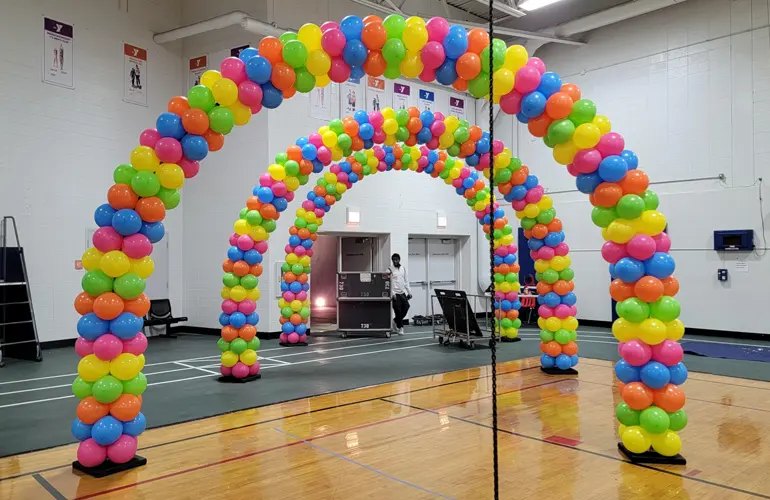 Indoor balloon arch tunnel to welcome students to a school dance