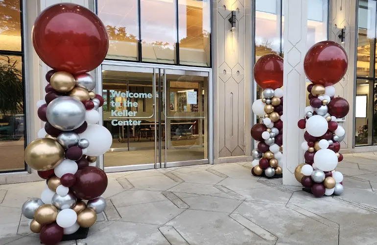 Outdoor organic balloon columns at campus entrance
