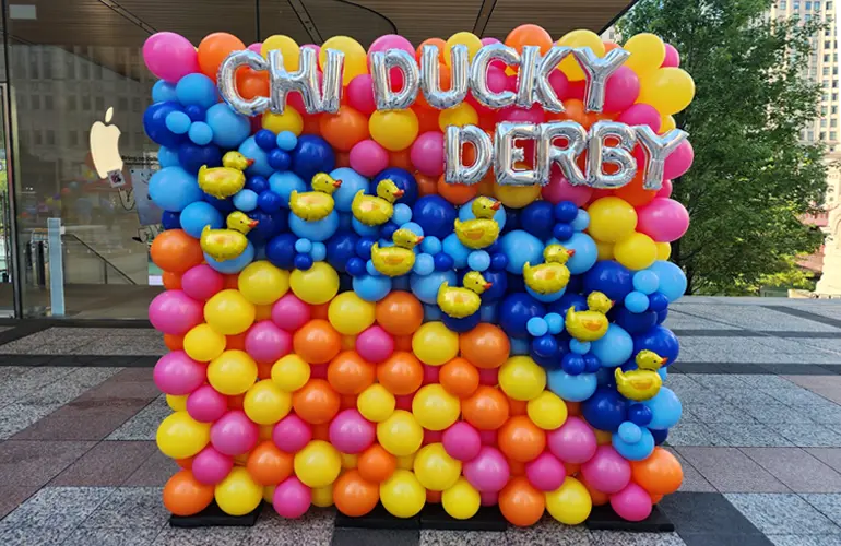 Balloon wall photo backdrop for the Chicago Ducky Derby with foil balloon letter accents