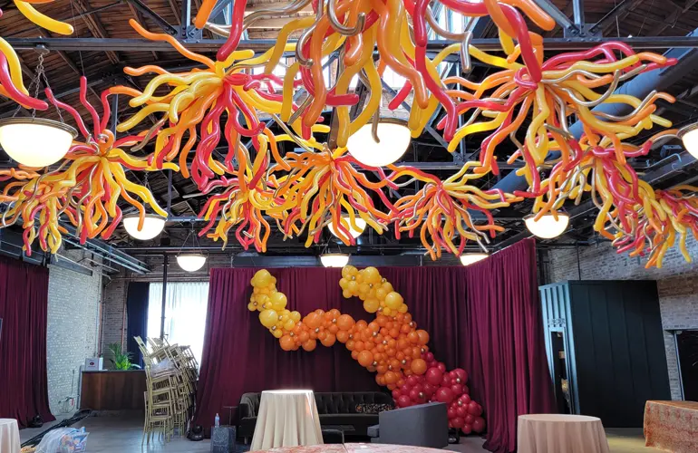 Organic balloon garland and ceiling decor for company gathering