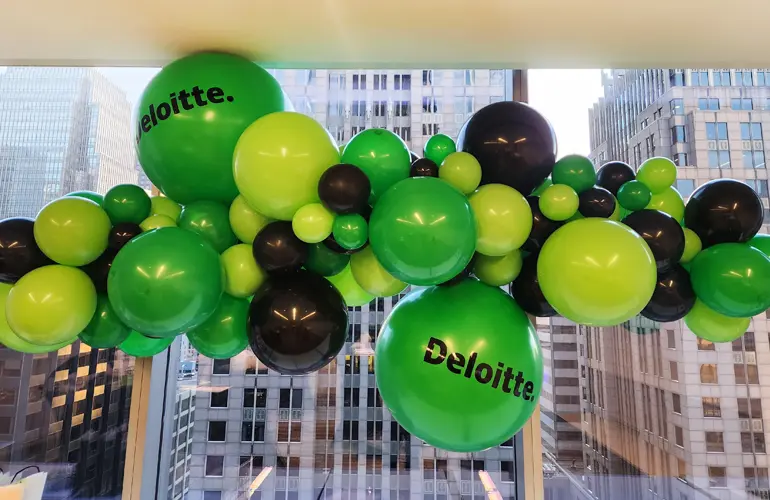 Organic balloon garland with Deloitte logo for office event