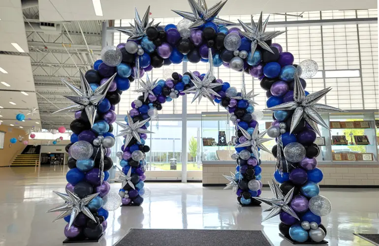 Space themed balloon arch entrance to school dance