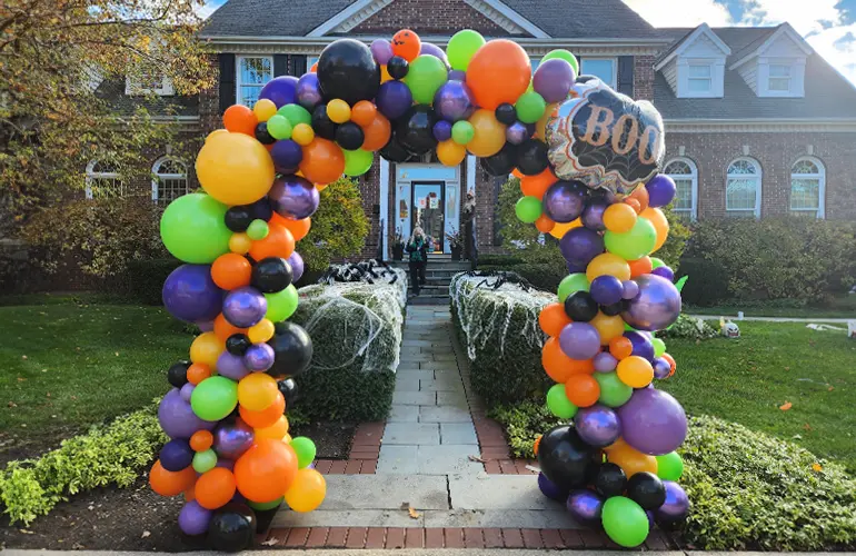 Organic balloon arch in front of house for Halloween trick-or-treating