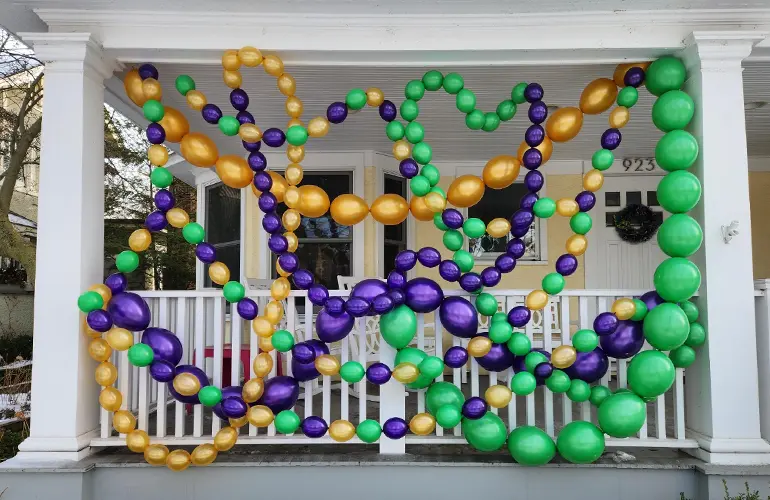 Balloon beads hanging on a front porch for Mardi Gras!