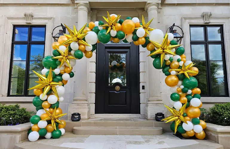 11ft wide organic styled balloon arch with starburst accents
                                        
