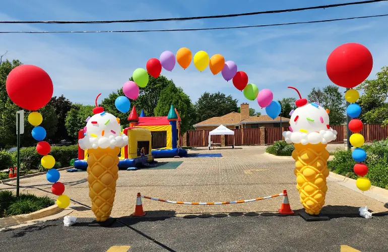 Outdoor balloon arch with ice cream cone balloon sculptures
