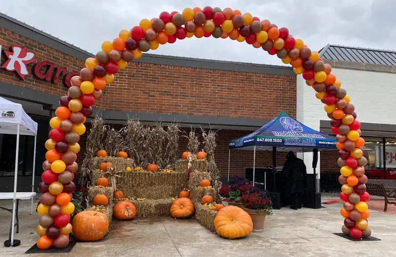 21ft Outdoor balloon arch in fall colors for a pumpkin event