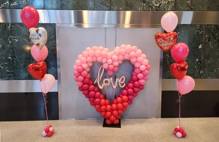 Balloon heart sculpture with bouquets