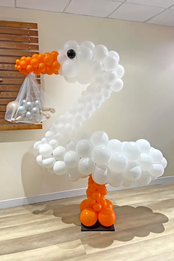 Balloon sculpture of a stork delivering a baby