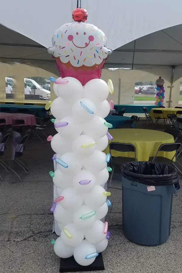 7.5ft balloon balloon column with foil shape topper and sprinkles along the column