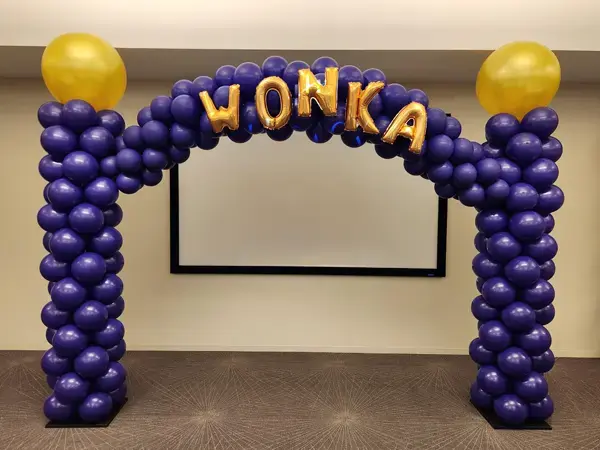 Willy Wonka inspired balloon arch with WONKA balloon letters on top