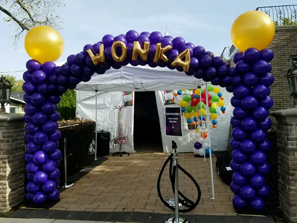 Willy Wonka inspired balloon arch with WONKA balloon letters on top