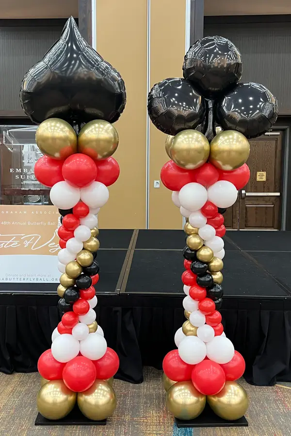 Roman style balloon columns with foil shape column toppers
