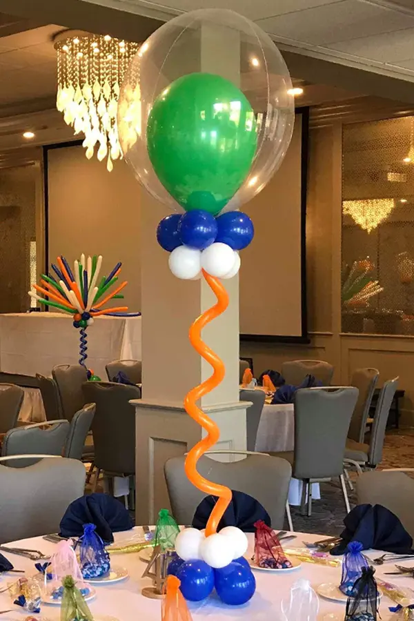 A creative filled balloon centerpiece using a balloon inside of a balloon