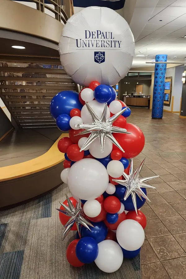 Organic balloon column with spike accents and a custom vinyl topper