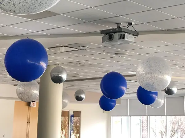 Ceiling balloon decor helps add color to the event space