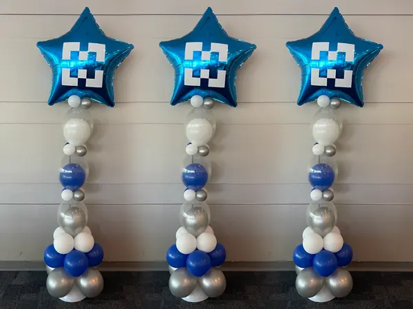 Skinny balloon column in school colors with a custom logo foil star topper