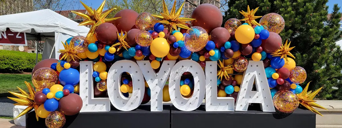 Loyola Alpha-Lit Letters with organic balloon garland decorations
