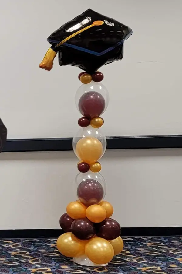 Skinny column with graduation hat foil balloon topper