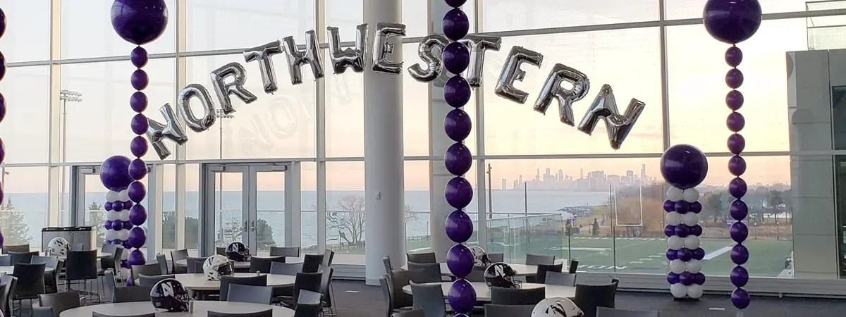 Balloon columns with foil letters spelling NORTHWESTERN for school event