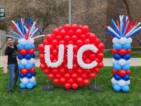 UIC logo sculpture with 2 classic balloon columns on each side