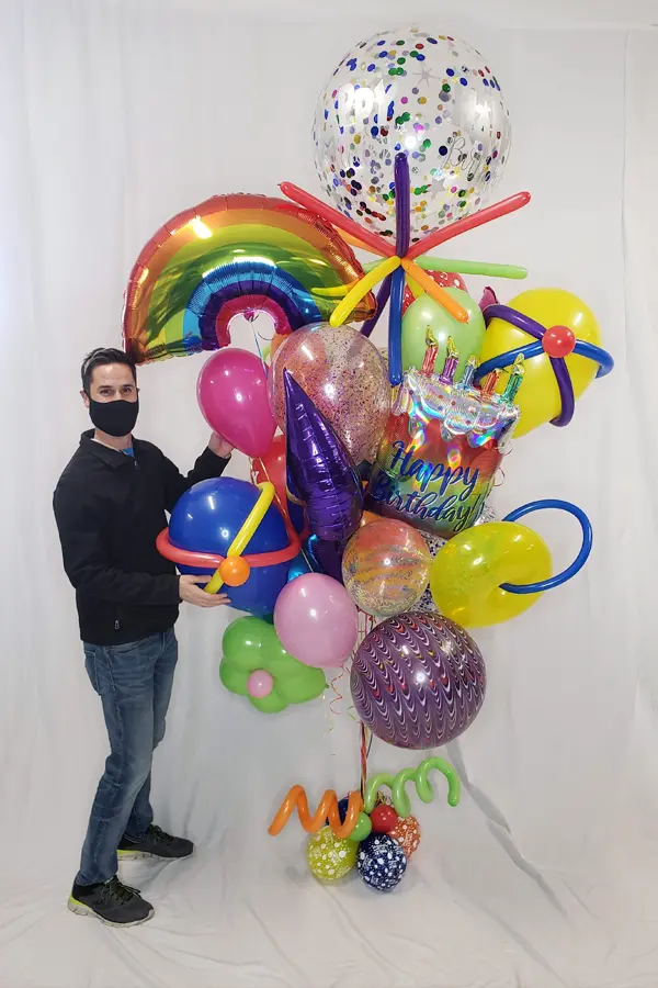 A whimsical balloon bouquet that uses multiple sized balloons
