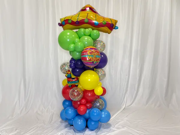 A festive organic styled balloon column with matching theme foil balloons