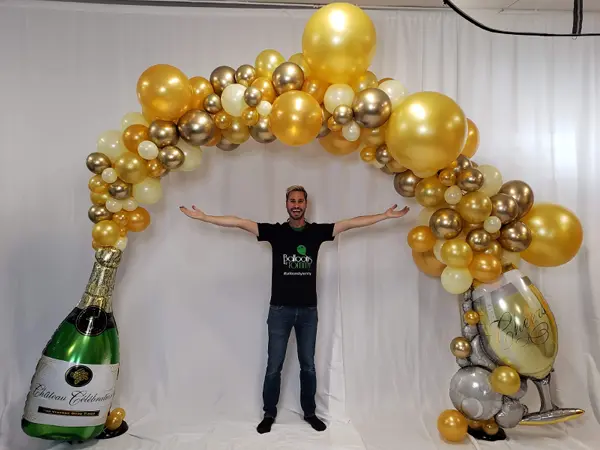 Organic arch with champagne bottle at the ends