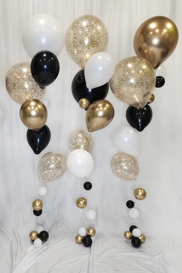 Trendy alternative to a classic bouquet using various balloon sizes creating a look of floating bubbles mixed with glitter balloons
