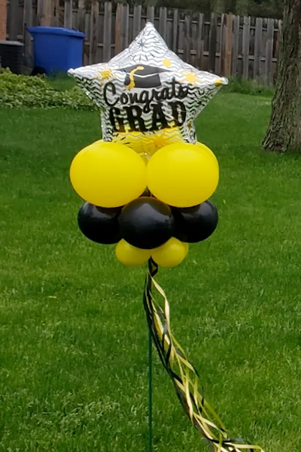 Yard decor with air filled graduation foil balloon