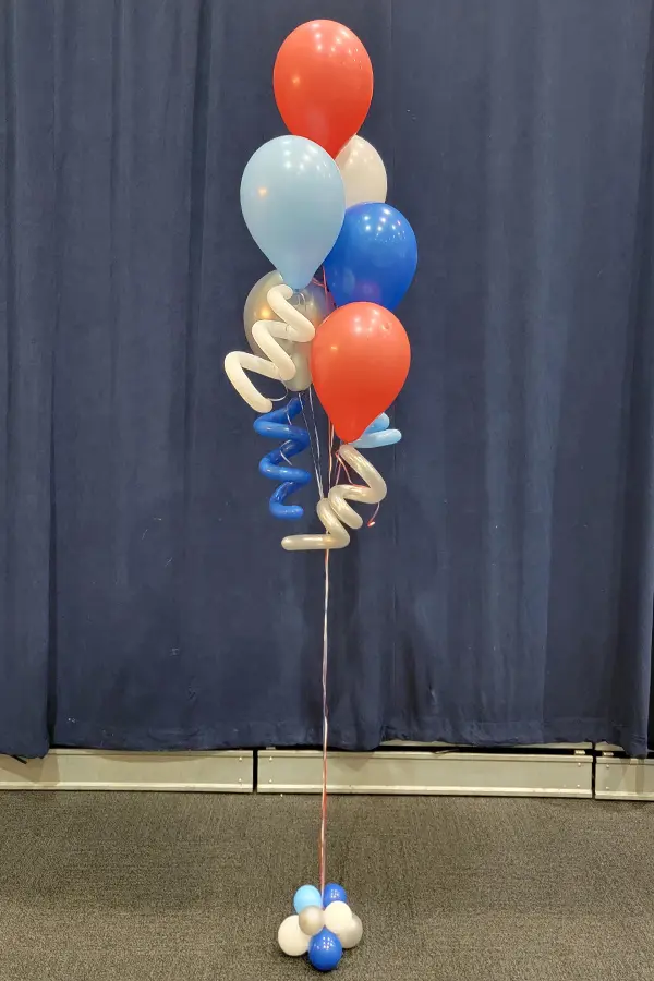 Classic balloon bouquet with squiggle accents in school colors