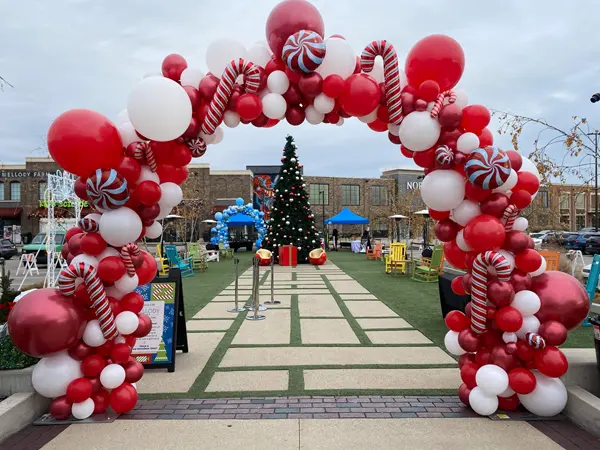 Organic balloon arch with candy cane foil balloon accents
