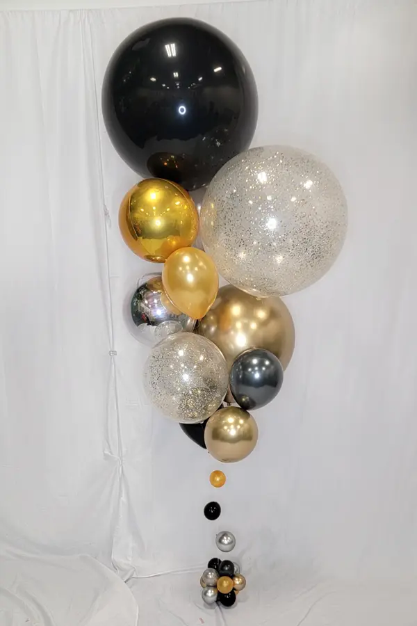 Larger than life balloon bouquet reaching 10ft tall using a mix of balloon sizes and glitter balloons
