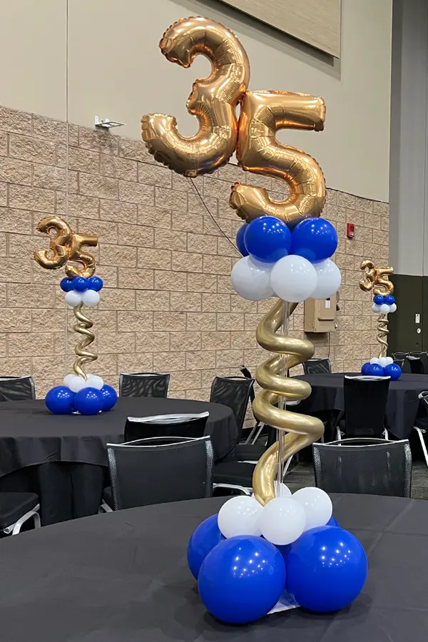 Pedestal balloon centerpiece with oil balloon numbers on top