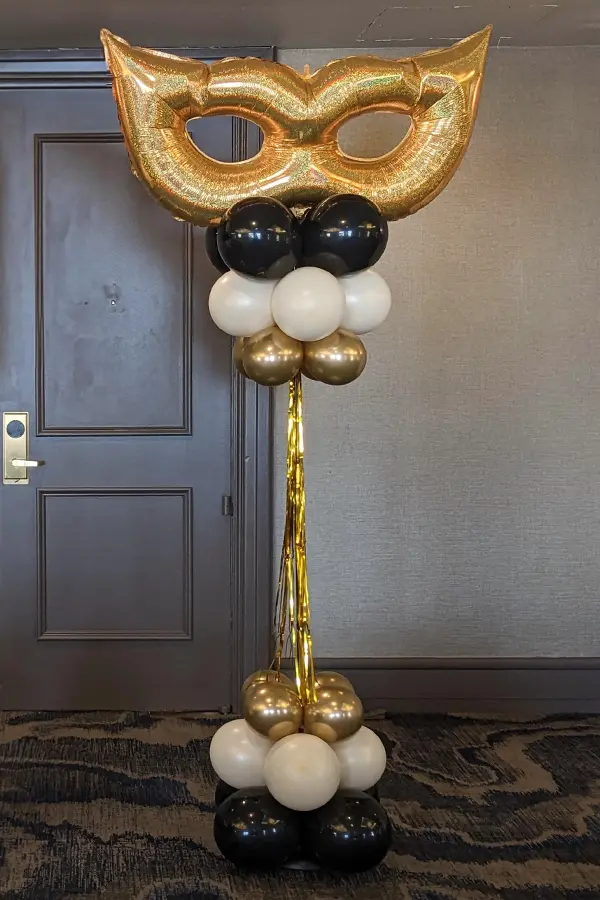 Foil mask topped balloon column with streamers