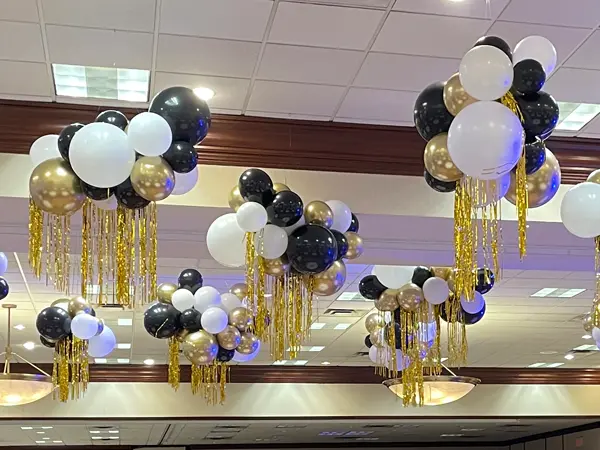 Air filled balloon clusters with fringe that hang from the ceiling