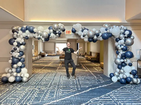 Organic garland attached to a classic balloon wall for a unique photo backdrop