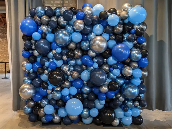 Create an ideal photo backdrop with an organic styled balloon wall to match your event theme or decoration colors
