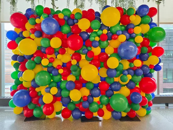 Create an ideal photo backdrop with an organic styled balloon wall accented with glitter balloons, confetti balloons, foil spikes, or foil orbs to match your event theme or decoration colors