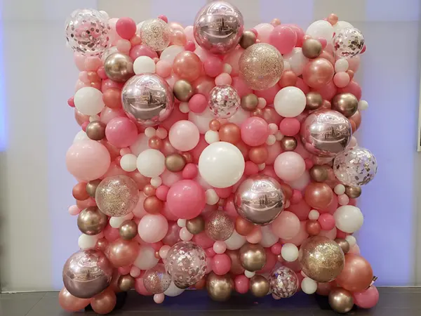 Create an ideal photo backdrop with an organic styled balloon wall accented with glitter balloons, confetti balloons, foil spikes, or foil orbs to match your event theme or decoration colors