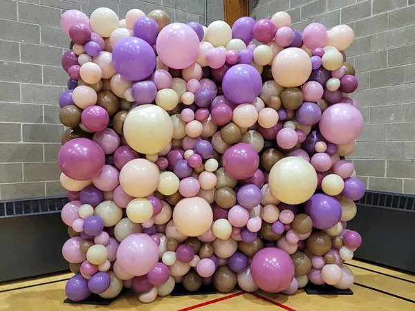 Create an ideal photo backdrop with an organic styled balloon wall to match your event theme or decoration colors