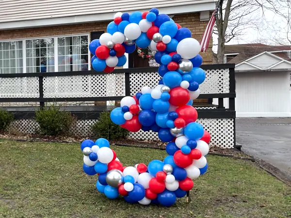 5ft tall organic balloon sculpture of the number 3 for a birthday celebration
