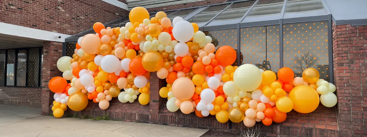 Organic balloon garland on the outside of a building