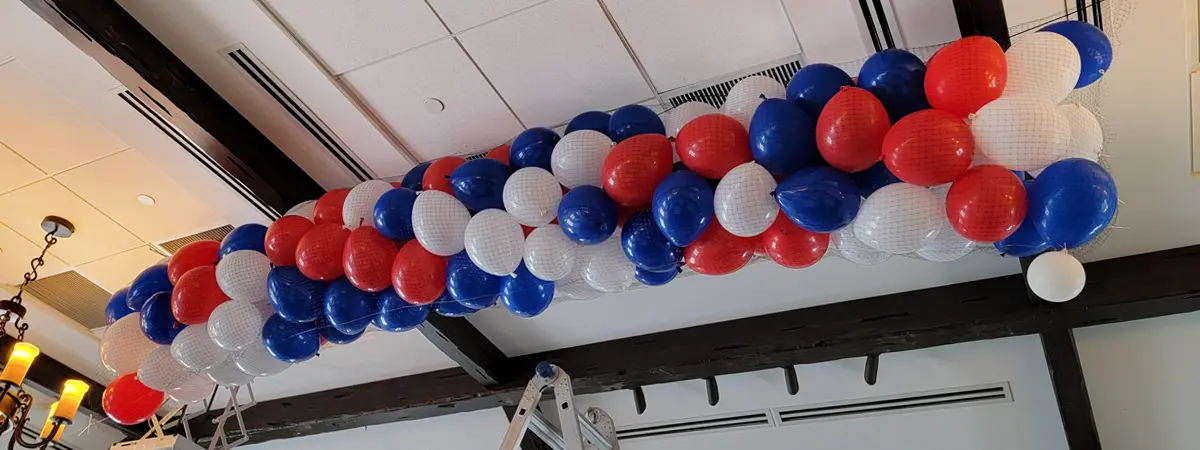 Classic balloon drop filled with red white and blue balloons