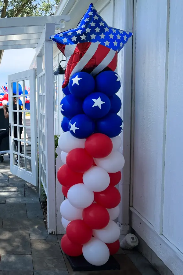 Classic balloon column in a flag styled pattern with a foil star topper