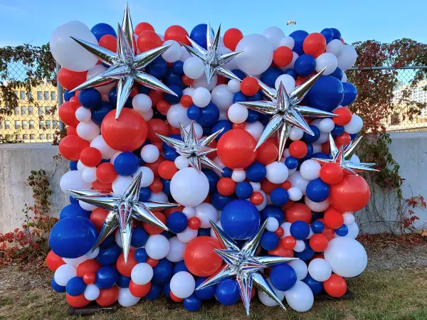 Organic balloon wall in red white and blue with silver foil starburst accents