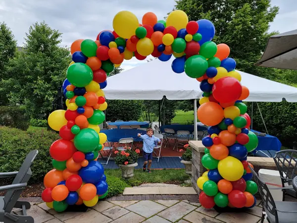 Large foil balloon shape on top of an indoor and outdoor pedestal base creating a balloon centerpiece