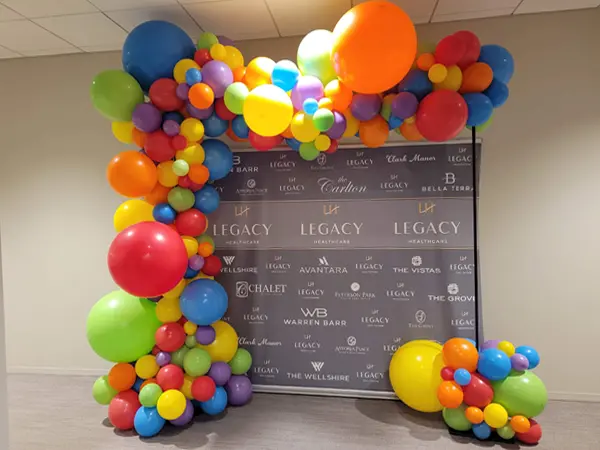 Large foil balloon shape on top of an indoor and outdoor pedestal base creating a balloon centerpiece