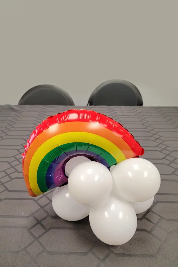 Small rainbow foil balloon on a mini cloud made from white latex balloons